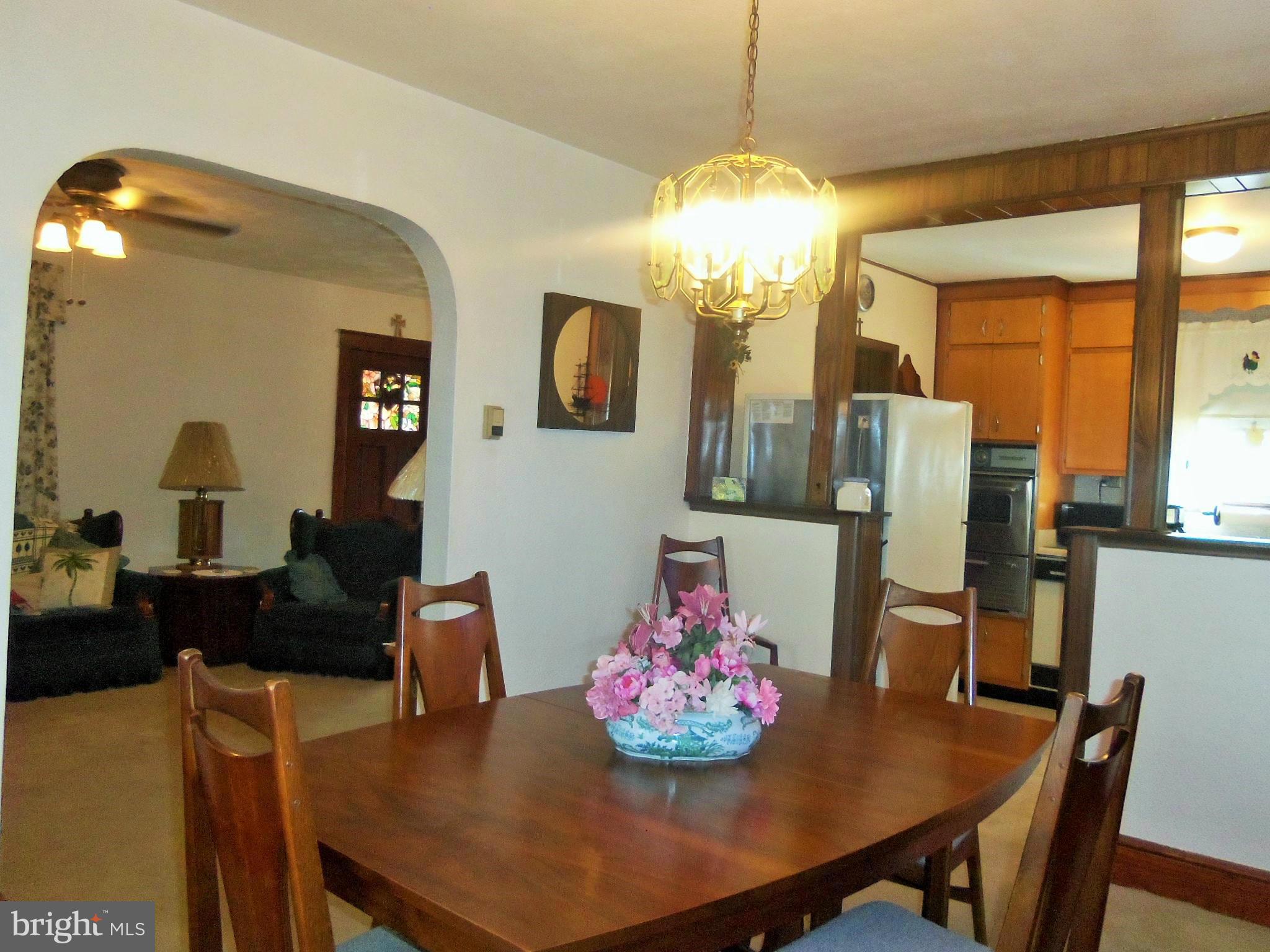 5574 Ashbourne Road Baltimore, MD 21227 - Photo 16 of 29 a view of a dining room with furniture and chandelier