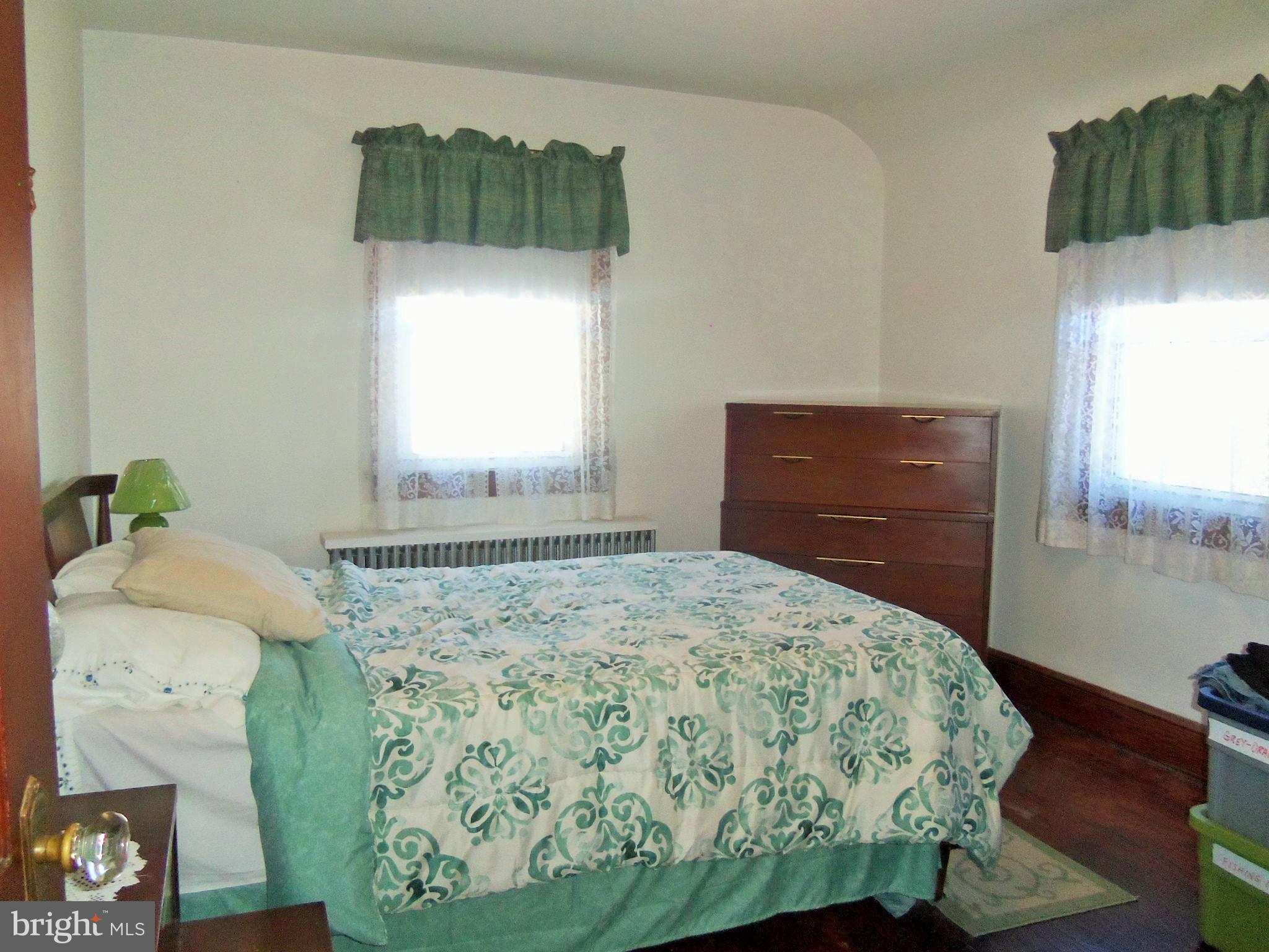 5574 Ashbourne Road Baltimore, MD 21227 - Photo 17 of 29 a bedroom with a bed and window