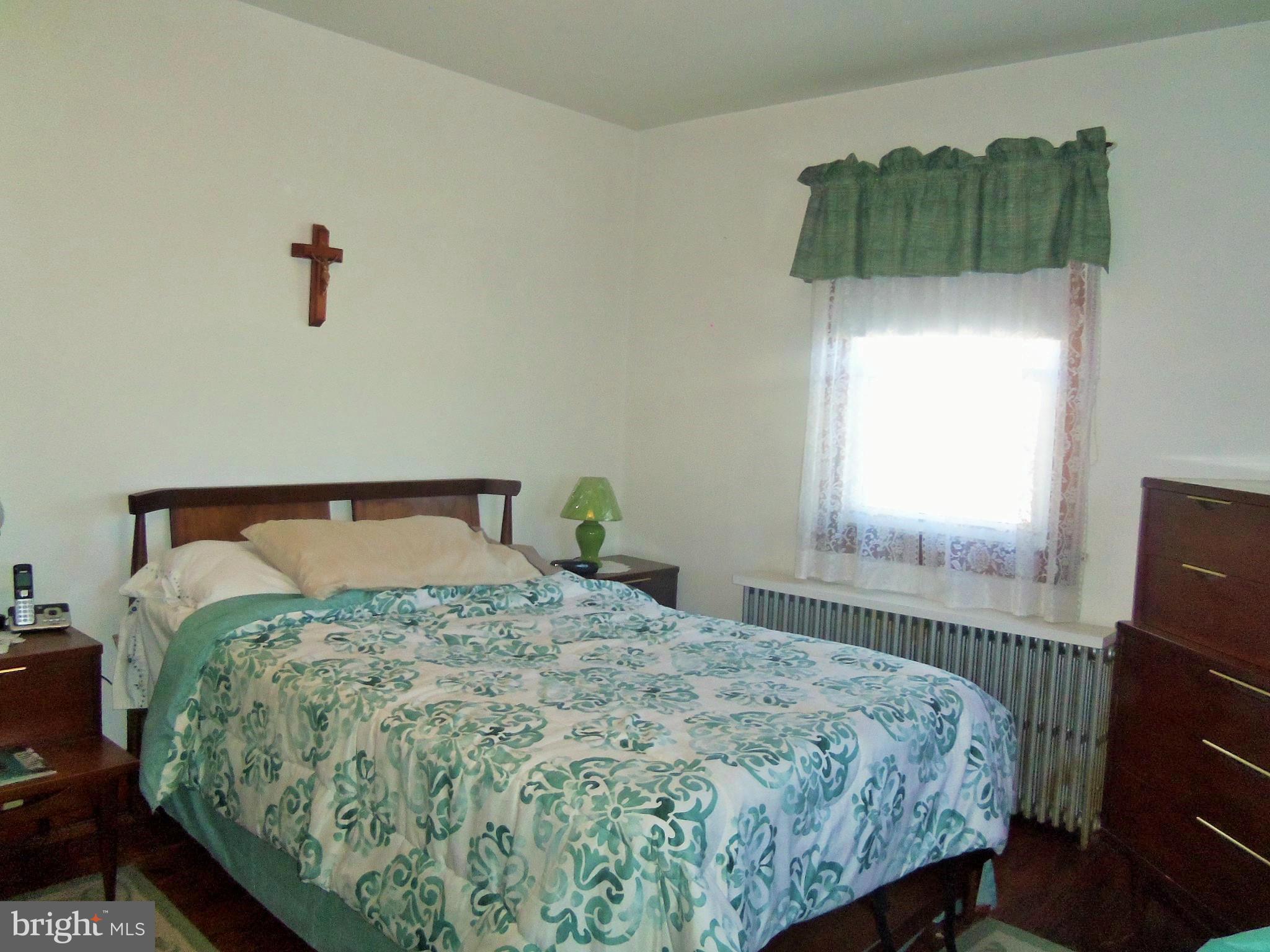 5574 Ashbourne Road Baltimore, MD 21227 - Photo 18 of 29 a bedroom with a bed and a window