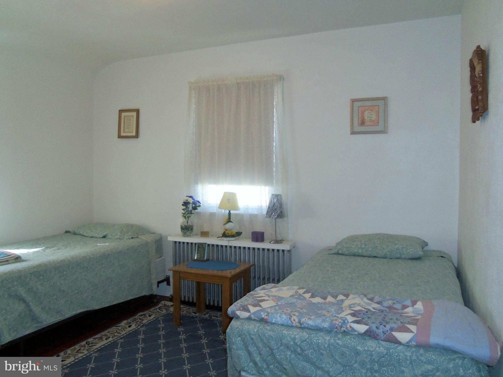 5574 Ashbourne Road Baltimore, MD 21227 - Photo 21 of 29 a bedroom with a bed and a window
