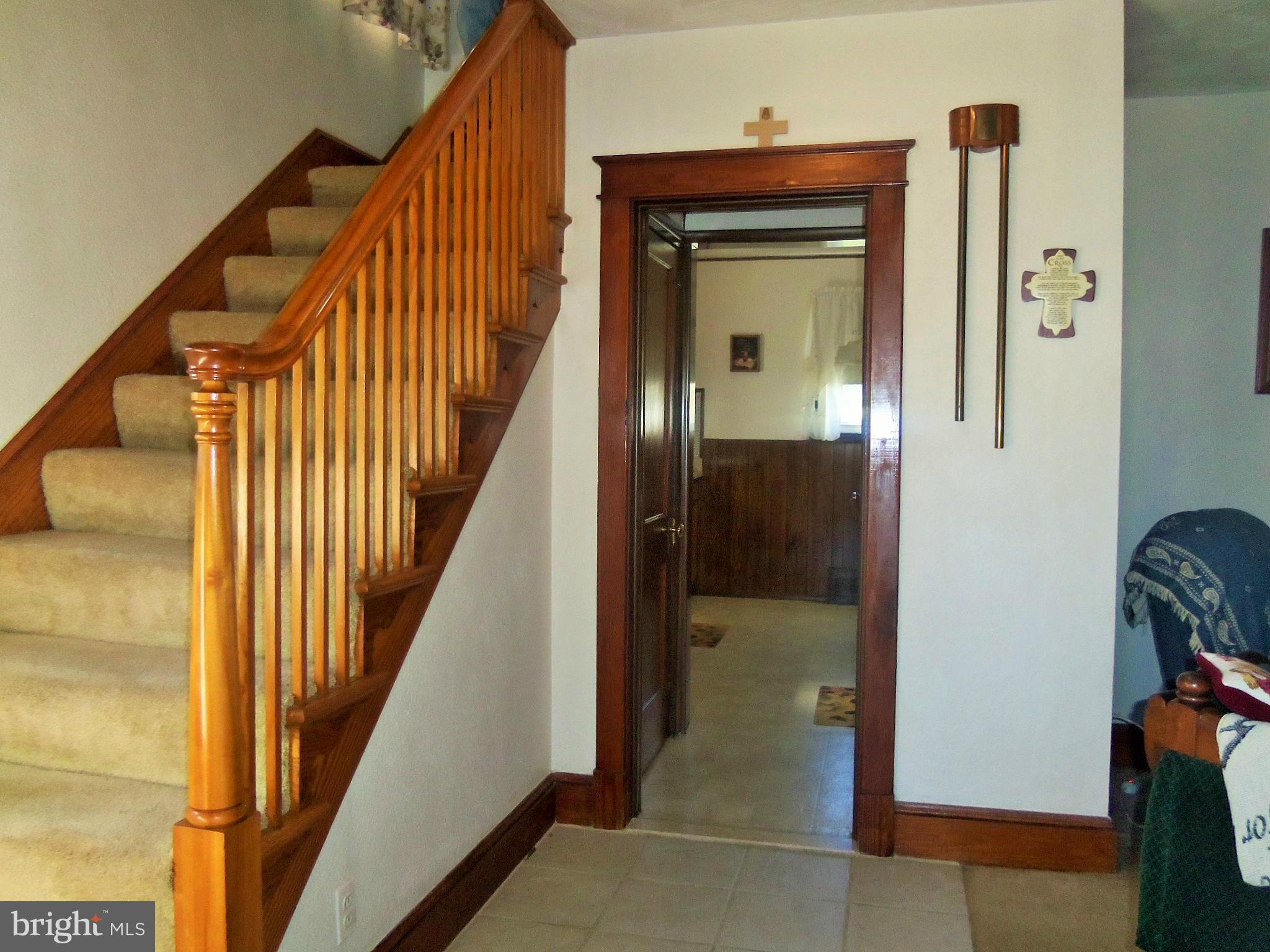 5574 Ashbourne Road Baltimore, MD 21227 - Photo 5 of 29 a view of a hallway with wooden floor and staircase