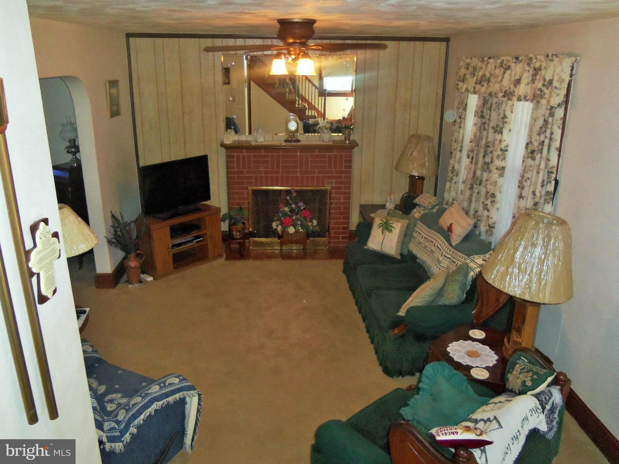 5574 Ashbourne Road Baltimore, MD 21227 - Photo 7 of 29 a living room with furniture and a flat screen tv