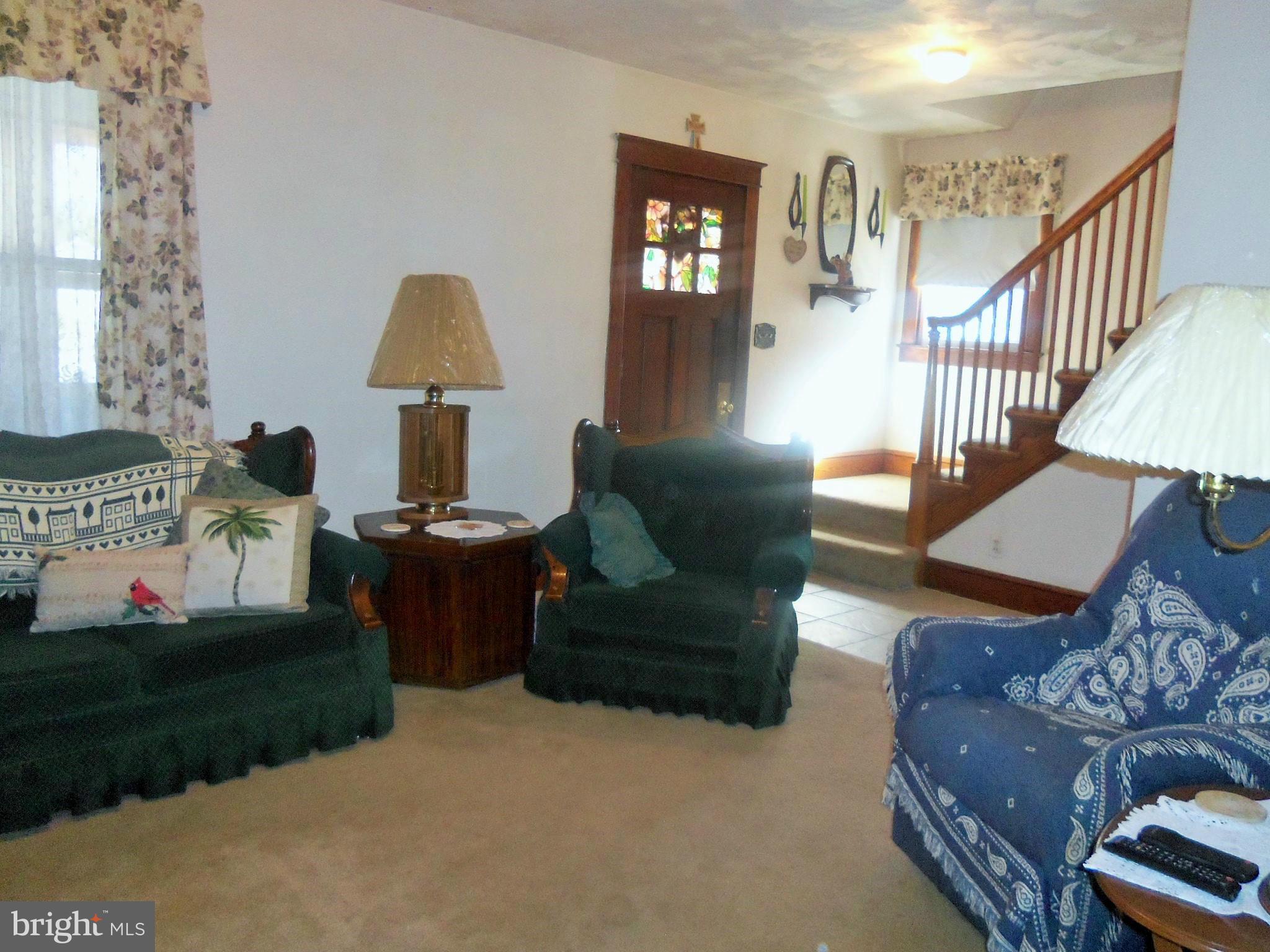 5574 Ashbourne Road Baltimore, MD 21227 - Photo 8 of 29 a living room with furniture and a lamp