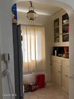 a kitchen with a refrigerator and window