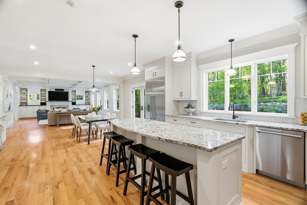 6 Flintlock Road Lexington, MA 02420 - Photo 12 of 39 a kitchen with stainless steel appliances granite countertop a stove a kitchen island a sink and white cabinets