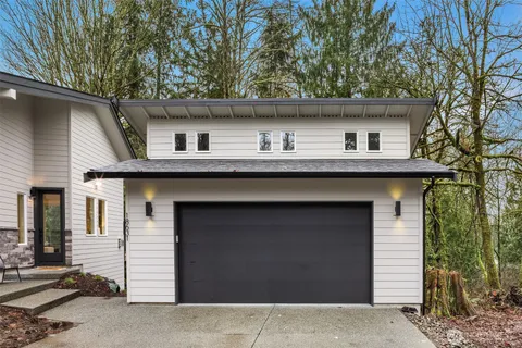 a view of a backyard with table and chairs under an umbrella