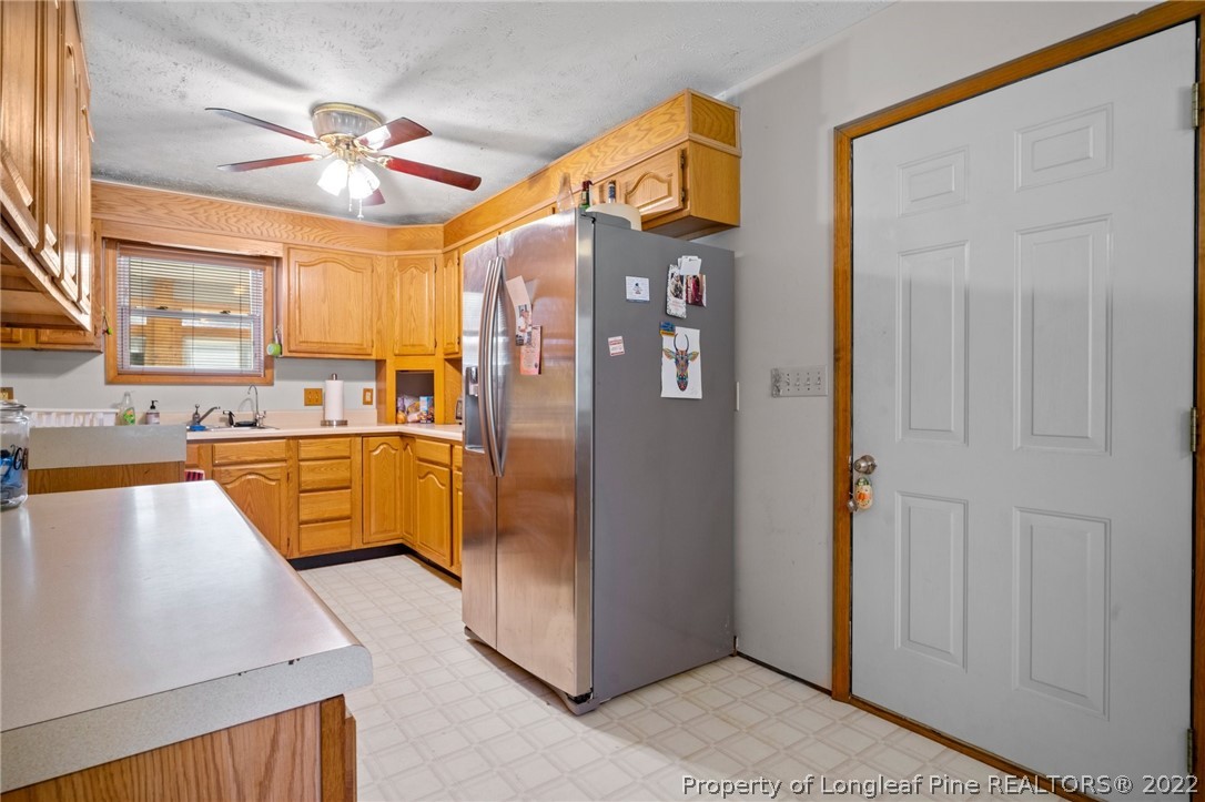 1519 Carl Freeman Road Stedman, NC 28391 - Photo 27 of 35 a kitchen with stainless steel appliances granite countertop a refrigerator and a sink