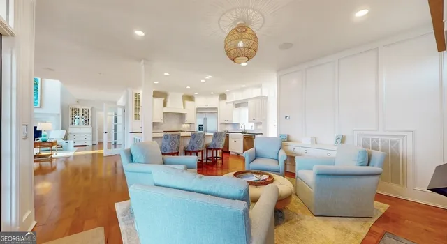 a open kitchen with kitchen island a stove a sink and a refrigerator