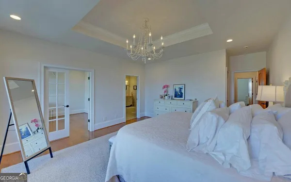a bedroom with a bed and a ceiling fan