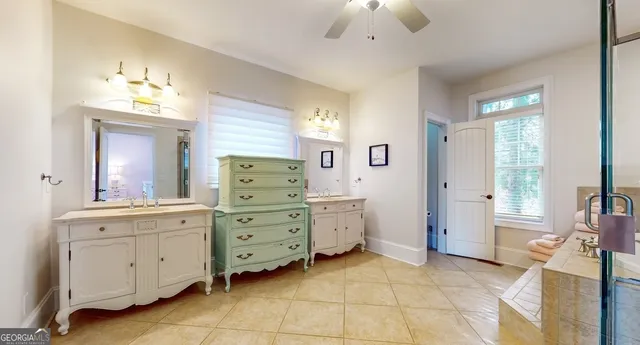 a living room with furniture ceiling fan and a flat screen tv