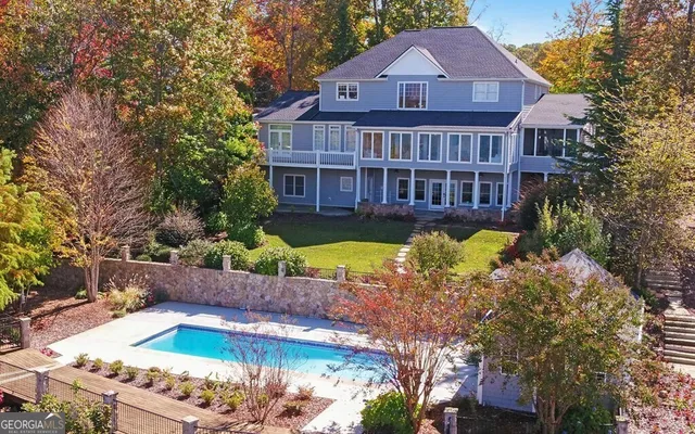a living room with fireplace furniture and a large window