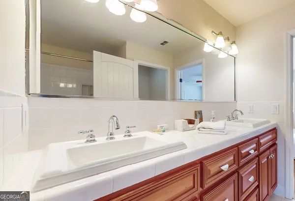 a view of a dining room with furniture a chandelier and wooden floor