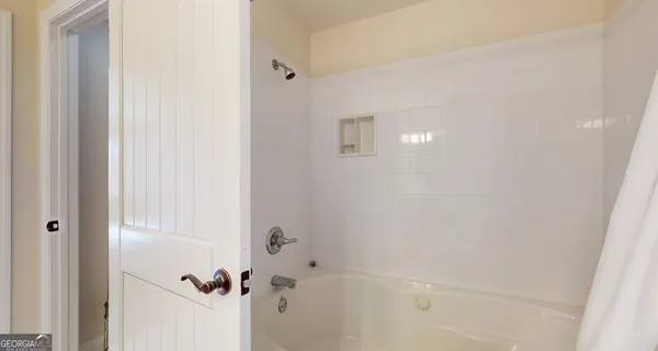a living room with furniture a window and a flat screen tv