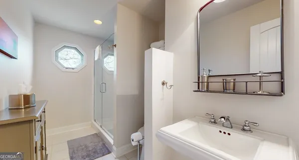 a bedroom with two beds and painting on the wall