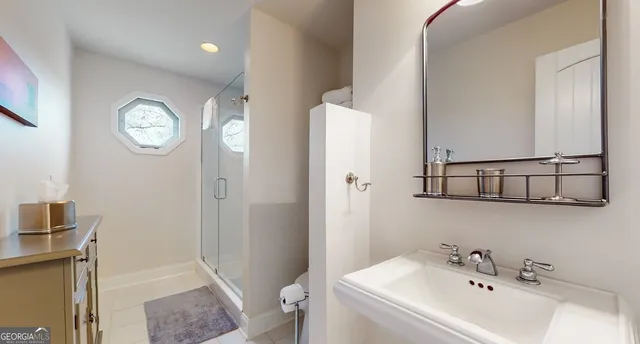 a bedroom with two beds and painting on the wall