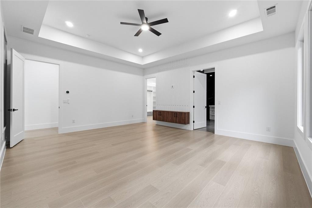 1563 Whitley Road Dacula, GA 30019 - Photo 17 of 44 a view of empty room with wooden floor and ceiling fan