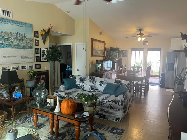 a living room with fireplace furniture and a chandelier