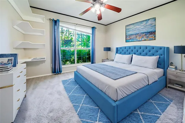 a spacious bedroom with a large bed and a chandelier