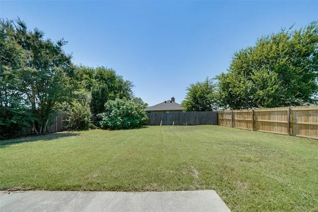 a backyard of a house with lots of green space