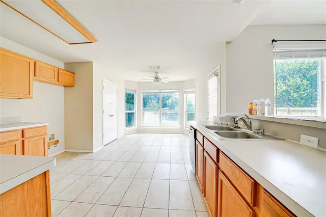 a spacious bathroom with a granite countertop sink and a bathtub