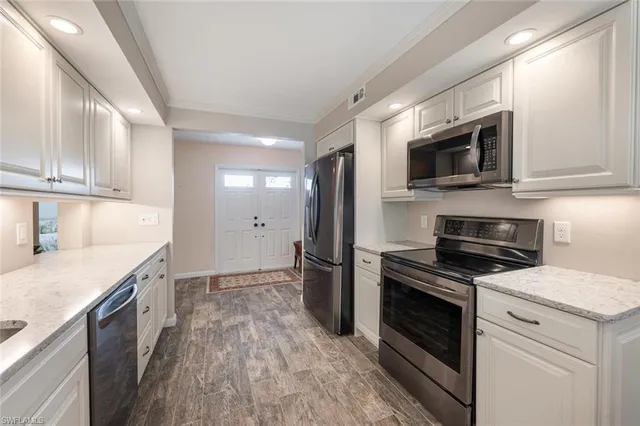 a kitchen with a stove microwave and sink