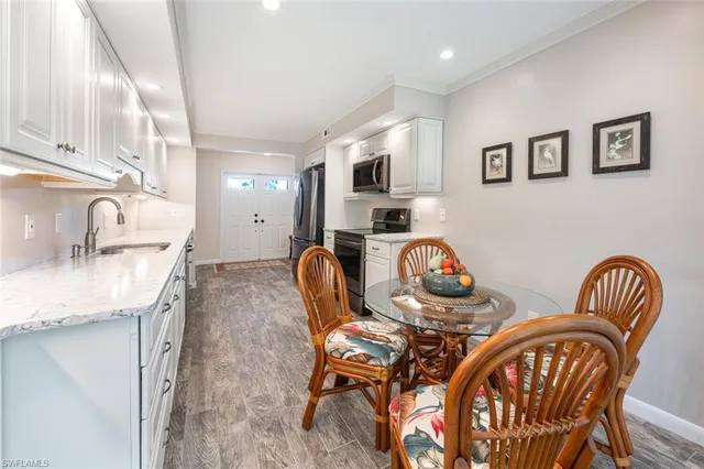 a living room with furniture a flat screen tv and a table