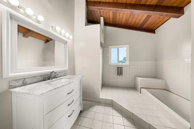 a bathroom with a sink a vanity and mirror