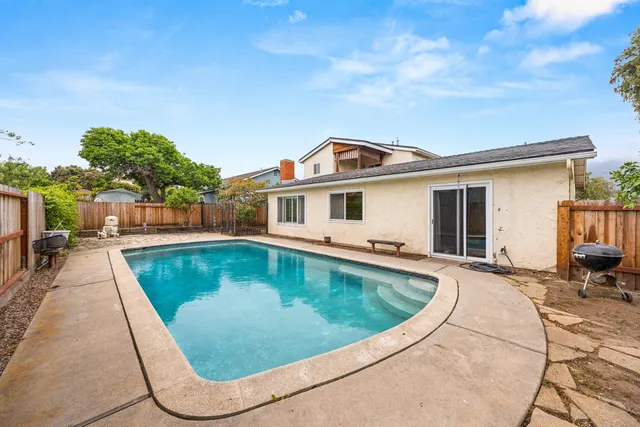 a view of a house with swimming pool and sitting area