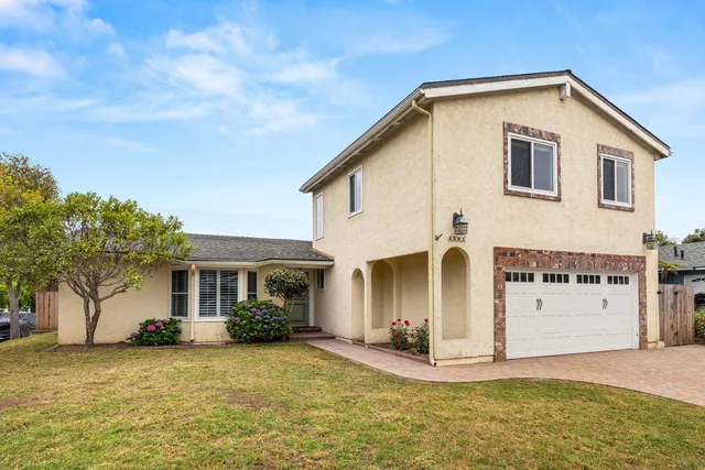 a front view of a house with a yard
