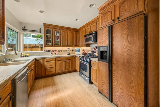 a kitchen with stainless steel appliances a sink stove and refrigerator