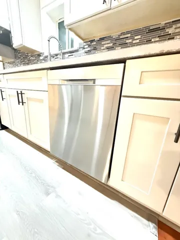 a view of a room with a window and wooden floor