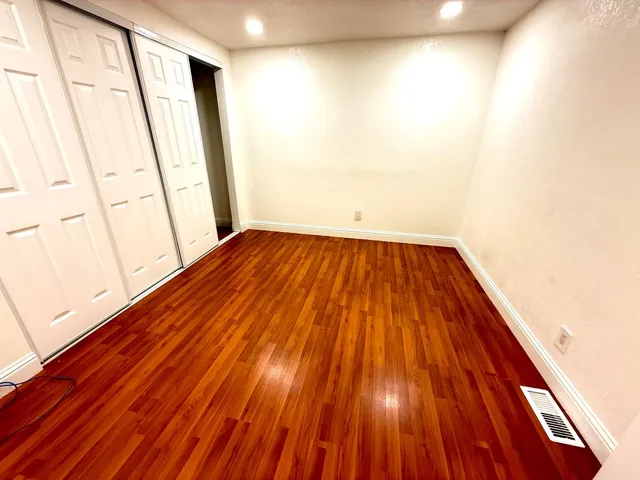 a view of a room with wooden floor and gate