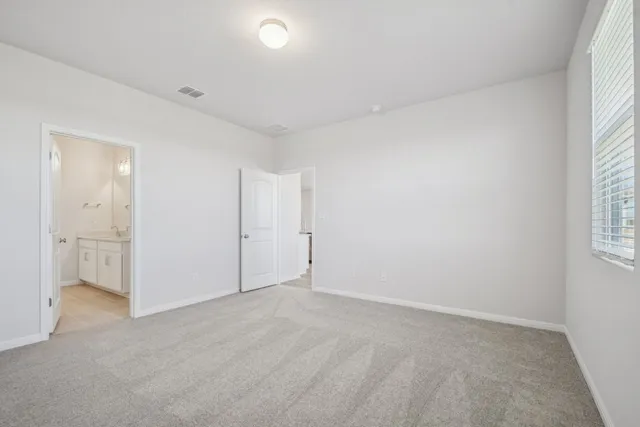 an empty room with windows and closet