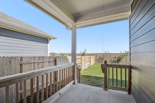 a view of a porch with a floor to ceiling window and wooden floor