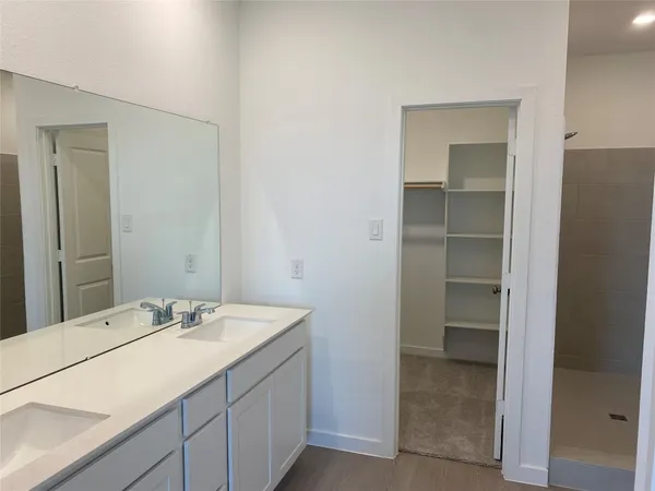 an empty room with closet and windows