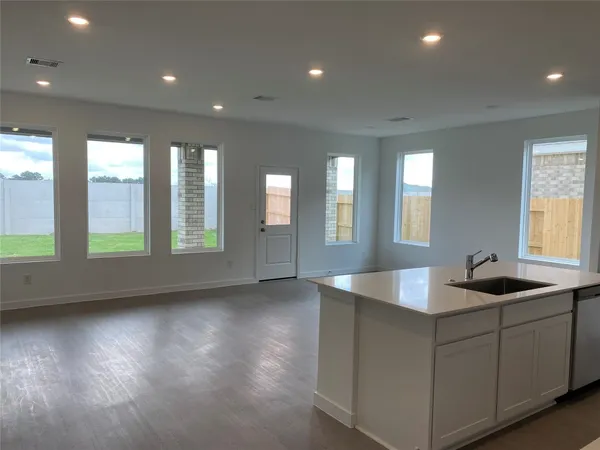 a large white kitchen with a sink