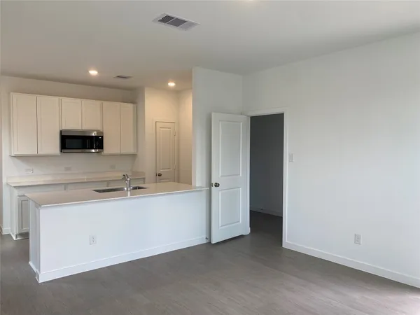a view of cabinets and microwave