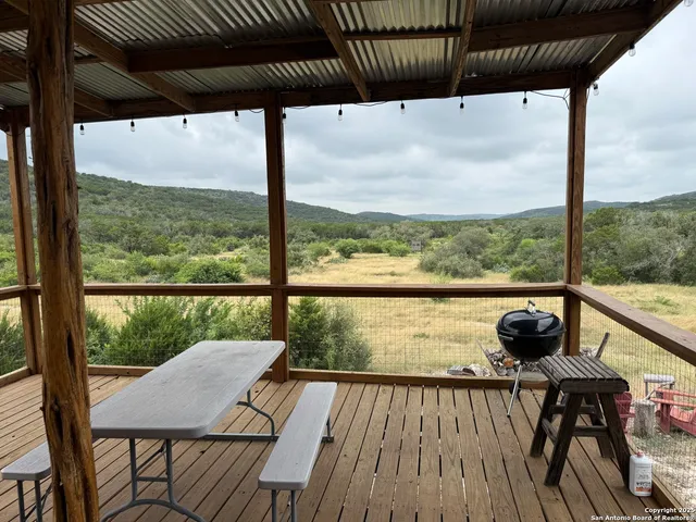 a view of a balcony with chair and wooden floor