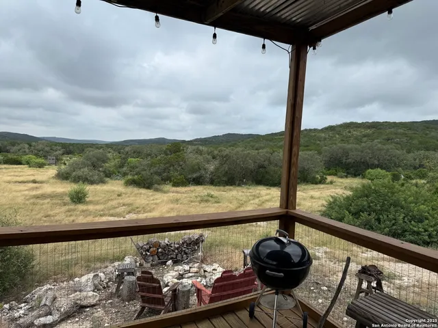 a view of a balcony with wooden floor and lake view