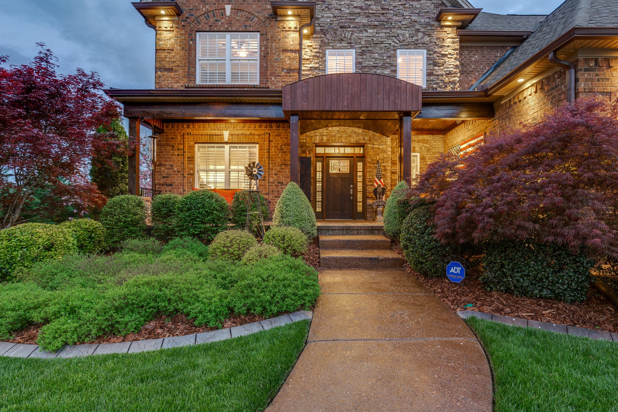 1052 Fitzroy Circle Spring Hill, TN 37174 - Photo 2 of 44 a view of a house with brick walls and a small yard