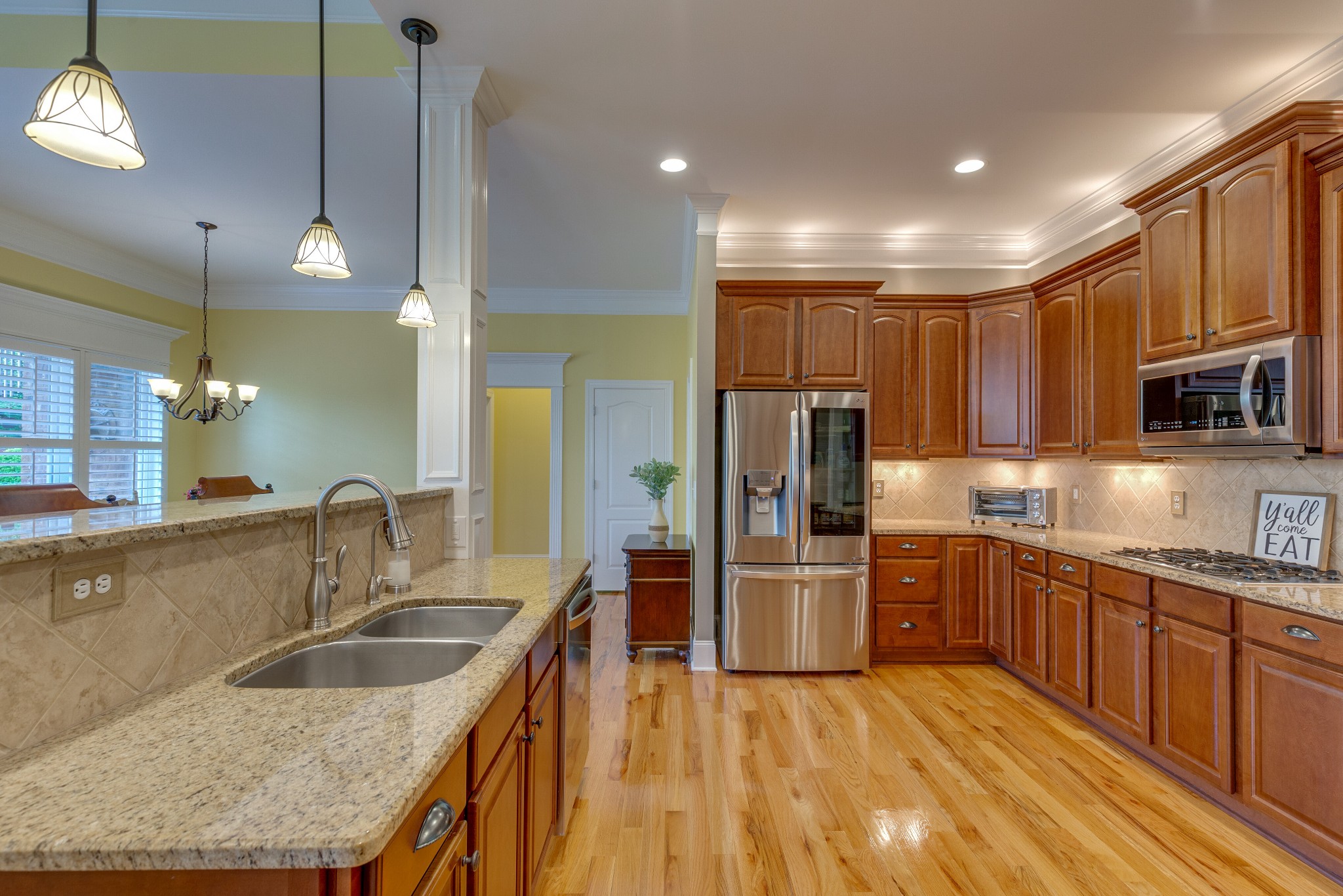 1052 Fitzroy Circle Spring Hill, TN 37174 - Photo 15 of 44 a kitchen with stainless steel appliances granite countertop a sink refrigerator and cabinets