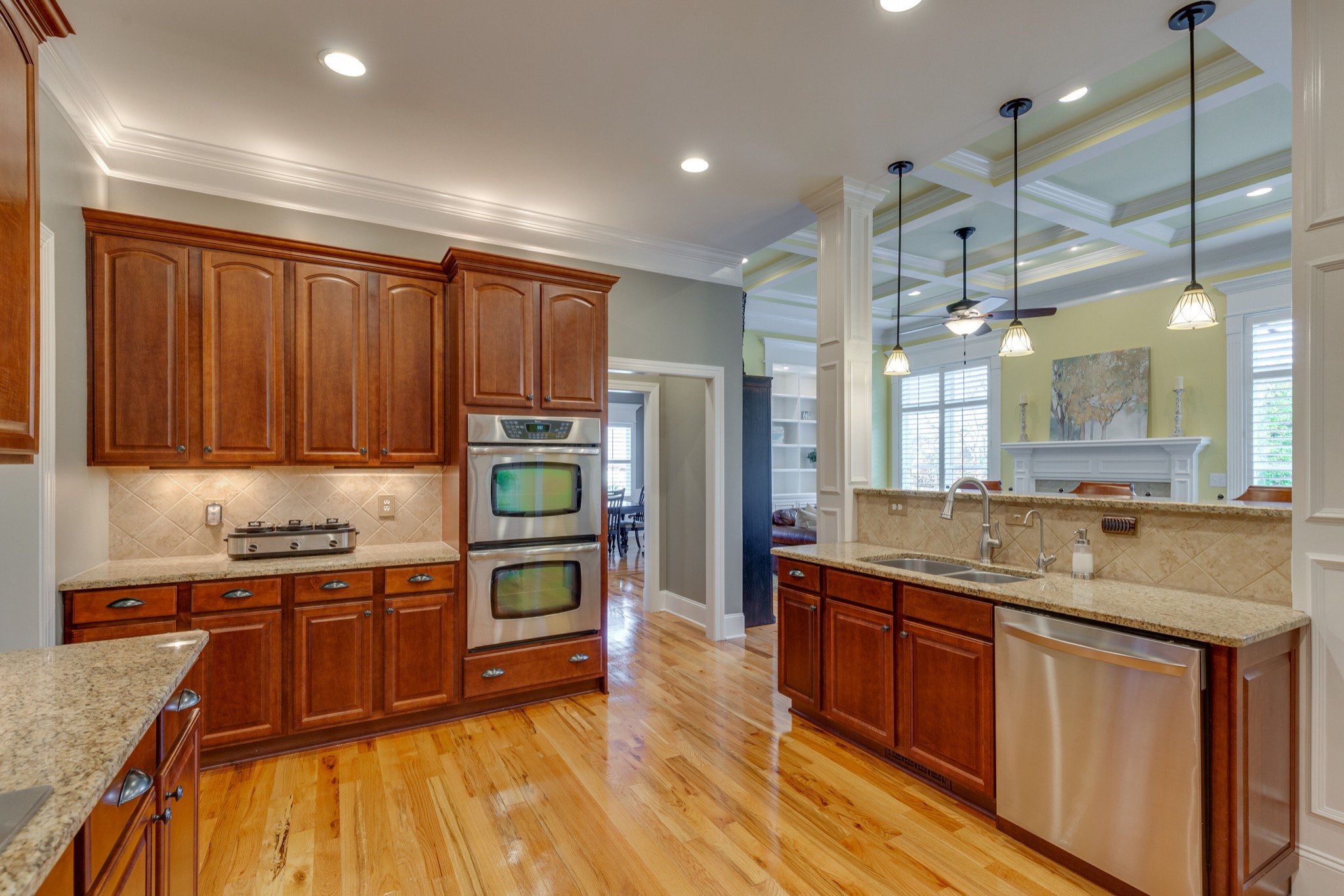 1052 Fitzroy Circle Spring Hill, TN 37174 - Photo 16 of 44 a kitchen with stainless steel appliances granite countertop a sink a stove and a wooden floors