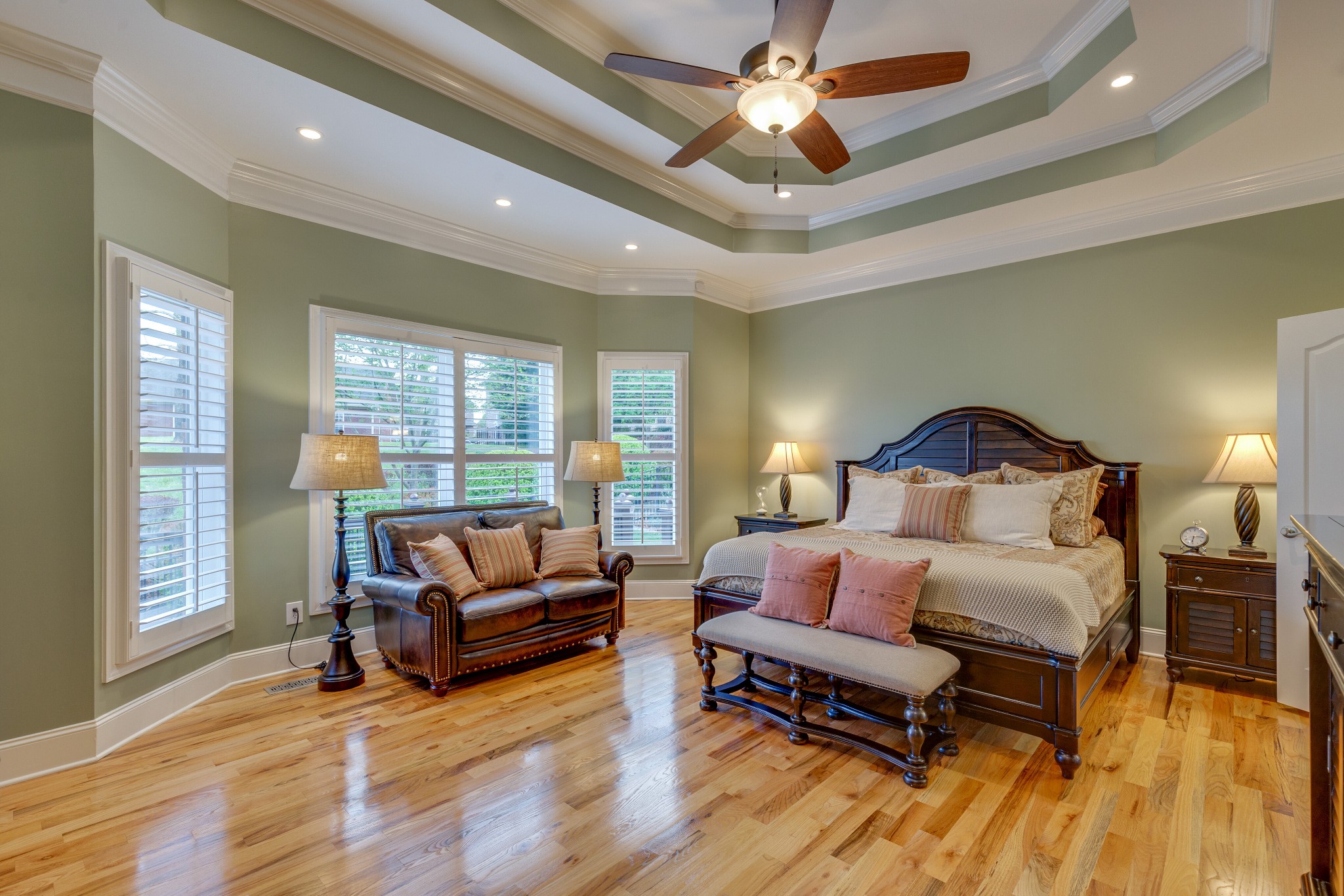 1052 Fitzroy Circle Spring Hill, TN 37174 - Photo 18 of 44 a spacious bedroom with a bed a couch and a chandelier