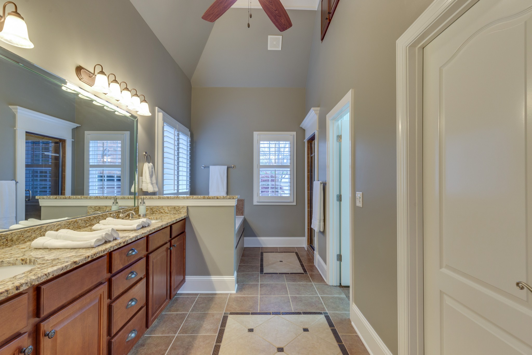 1052 Fitzroy Circle Spring Hill, TN 37174 - Photo 20 of 44 a spacious bathroom with a granite countertop sink a mirror and a