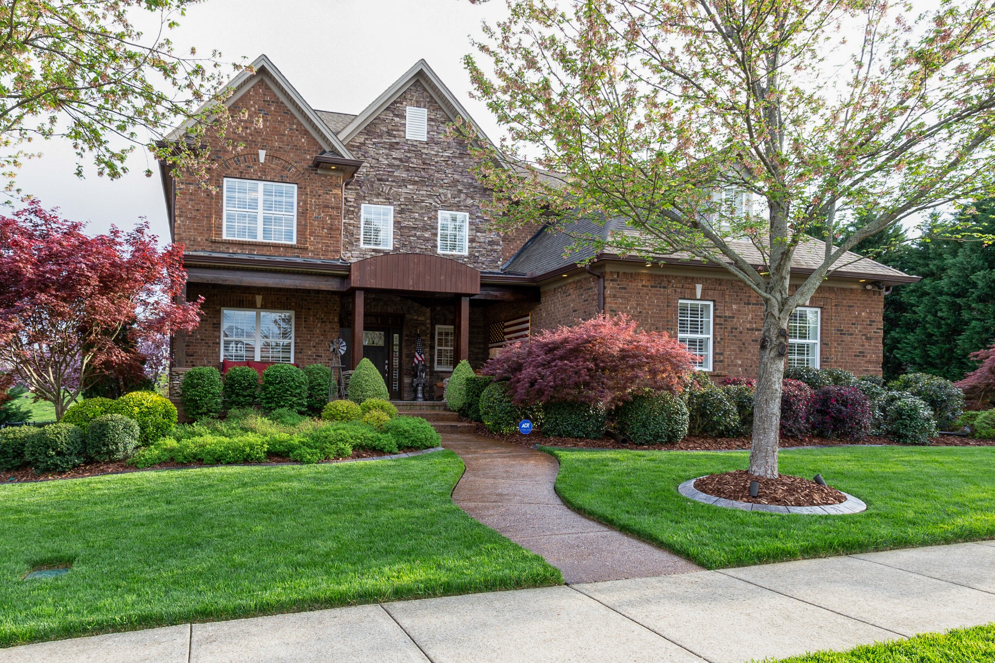 1052 Fitzroy Circle Spring Hill, TN 37174 - Photo 4 of 44 a front view of a house with a yard and garage