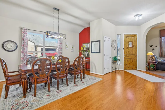 a view of a dining room with furniture and chandelier