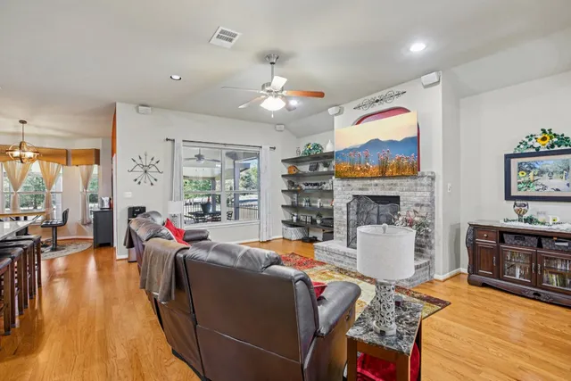 a living room with fireplace furniture and a flat screen tv