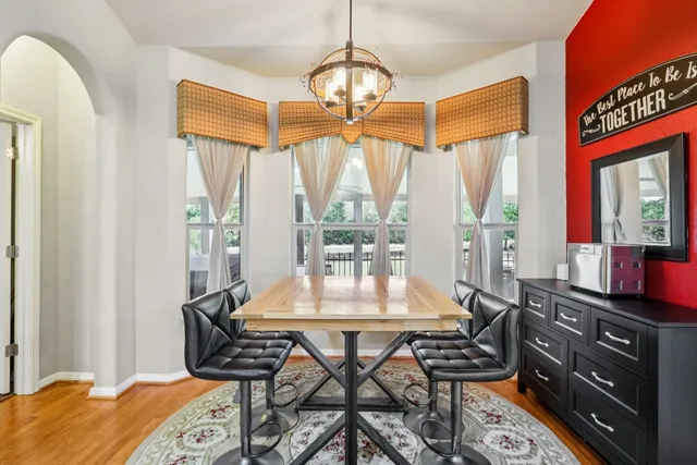 a dining room with furniture a chandelier and a rug