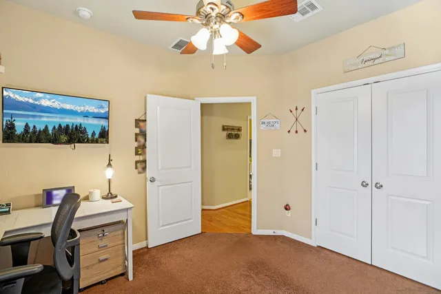 a view of a workspace with furniture and a window