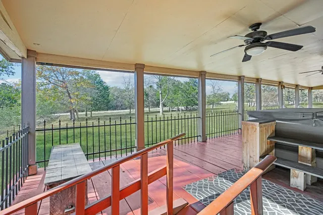 a living room with furniture a window and gym equipment